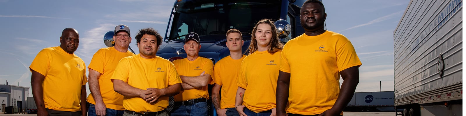 DTI drivers standing next to truck
