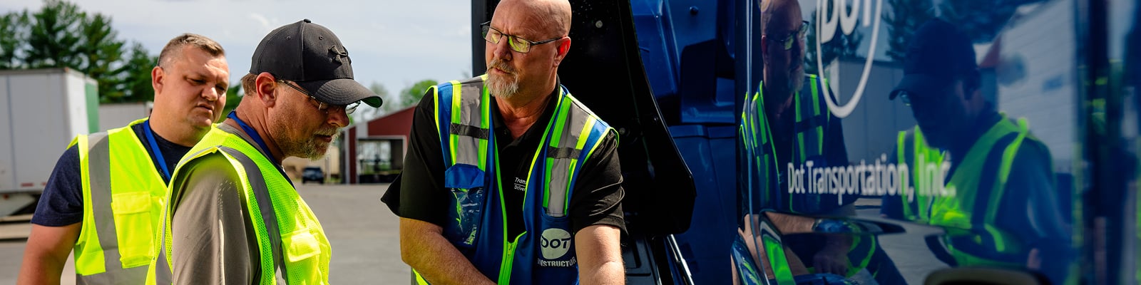 Driver trainer instructing students at a CDL driving school