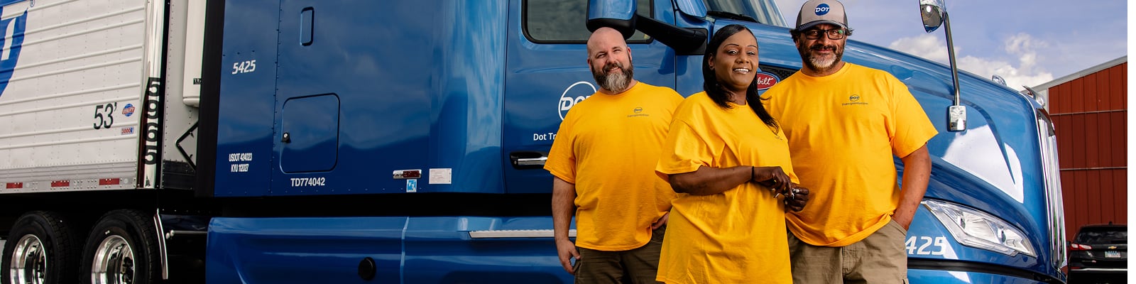 Three DTI drivers standing in front of truck